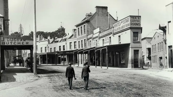 Historic Rocks streetscape with colonial buildings, shopfronts and unpaved street from early 1900s.