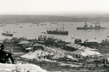 Historic Sydney Rocks waterfront with ships and colonial-era buildings, circa early 1900s.
