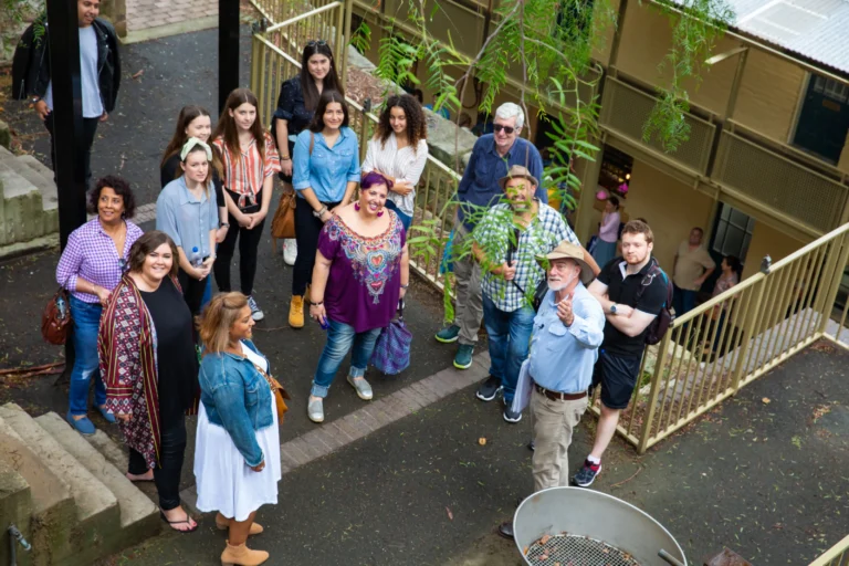 Guided walking tour group gathered in The Rocks historic laneway with local guide.