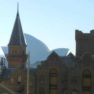 a large tall tower with a clock on the side of a building