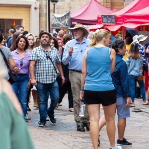 a crowd of people walking down the street