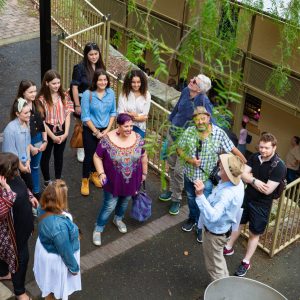 a group of people standing next to a fence