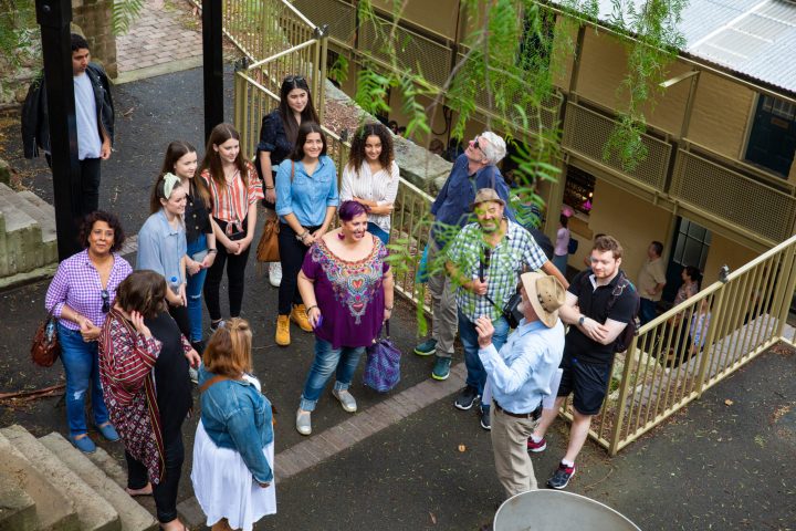 a group of people standing next to a fence