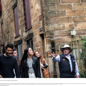 a group of people standing in front of a brick building