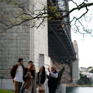 a group of people standing next to a tree